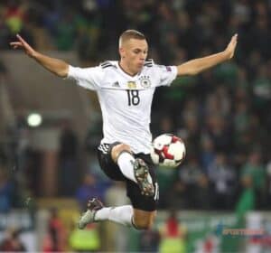 Joshua Kimmich in German Jersey with a football like Kungfu