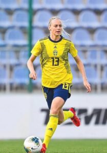 Amanda Ilestedt in Swedish Jersey with a ball