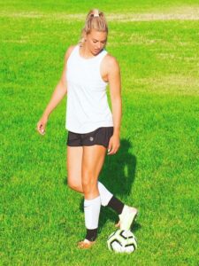 Lauren Sesselmann on field with a ball